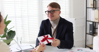 Employee receiving a thoughtful grocery store gift card as a token of appreciation.