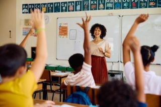 Teacher with students after receiving teacher appreciation gifts