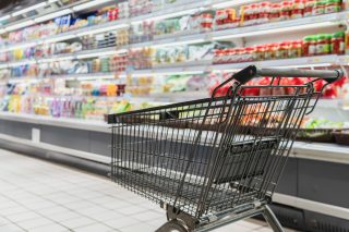Employee shopping with a grocery gift certificate at a supermarket checkout.