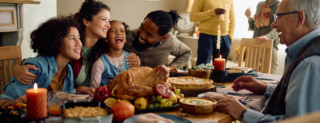 A family enjoying a festive holiday meal with turkey, thanks to a turkey voucher.